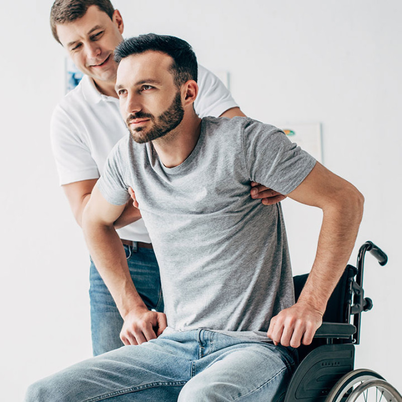 Person being helped up from wheelchair